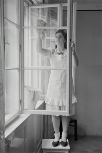 Housekeeper Cleaning a window