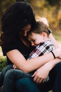 Family assistant hugging child
